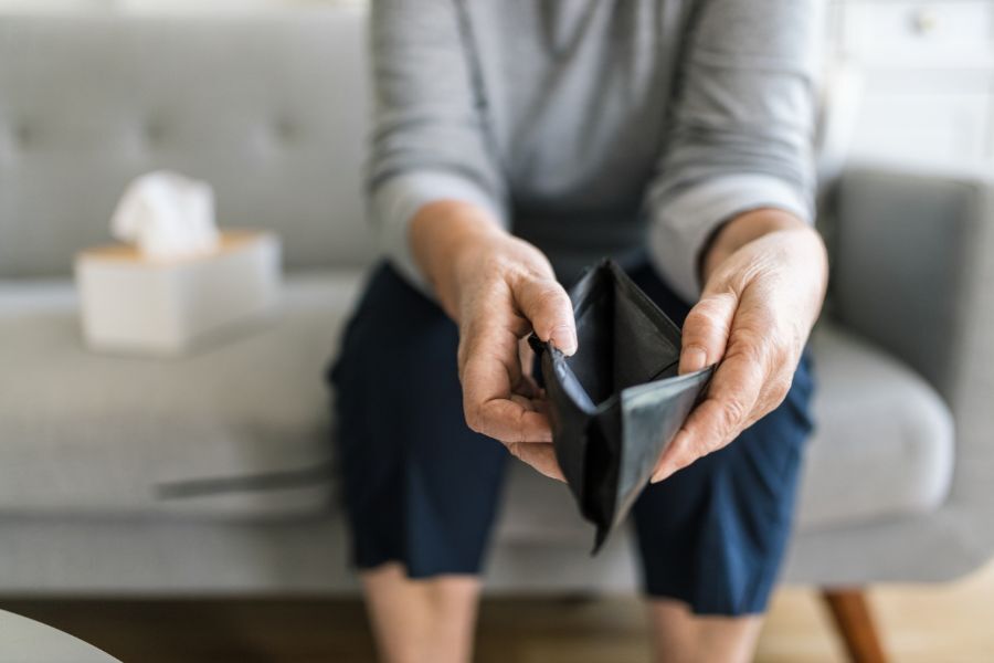 Elderly hands around an empty wallet