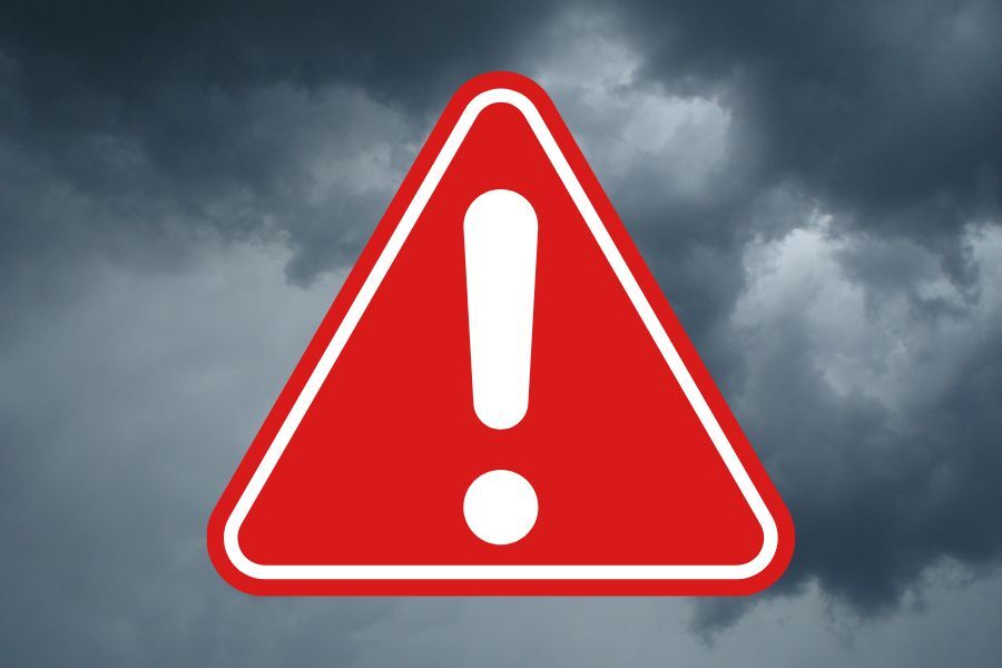 Red warning symbol on stormy background