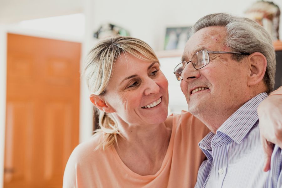 Woman caring for elderly man