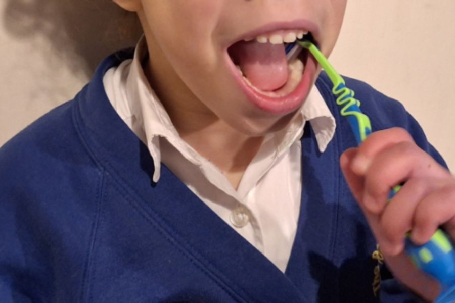 Young girl brushing her teeth