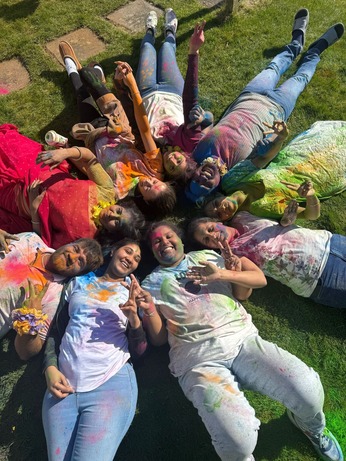 People covered in colourful dust