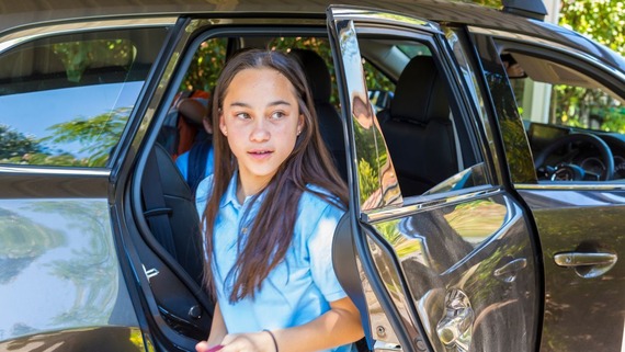 child getting out of a car