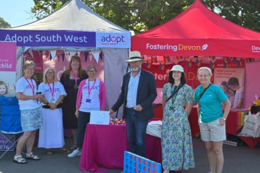 The Leader of the administration at Devon County Council, Cllr Julian Brazil, standing in front of the Adopt South West stand at the County Show