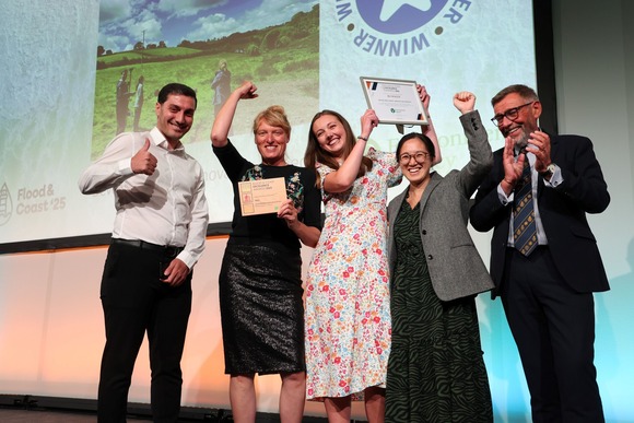 People stood on a stage celebrating an award