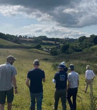 Group of people walking through a field