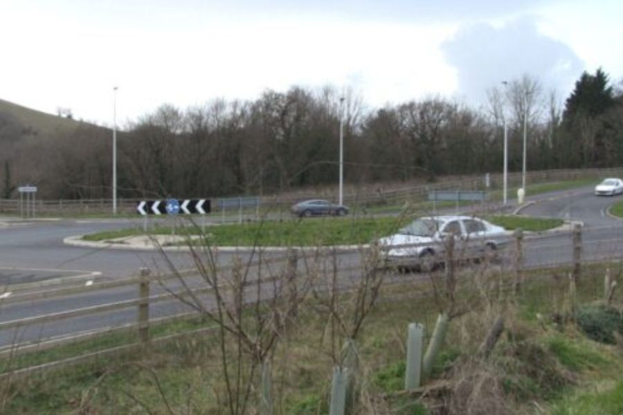 A car driving around a roundabout on the A382