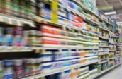 blurred image of colourful and fully stocked supermarket shelves