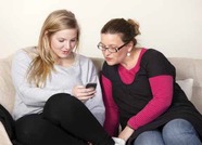 two young people looking at a tablet