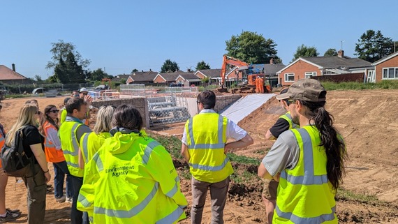 Members of the Flood and Water Management Group on a construction site looking at a new culvert entrance and trash screen