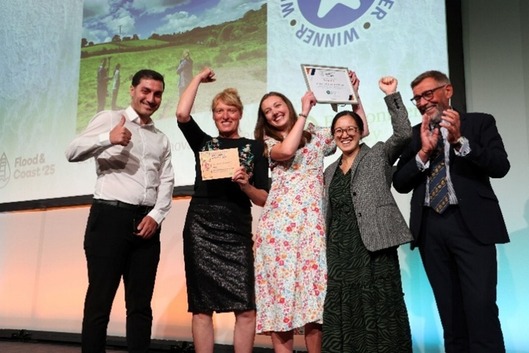 Members of the DRIP team on stage celebrating receiving their award