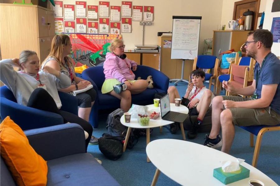 A group of young people, Champions for Change, talking to each other.