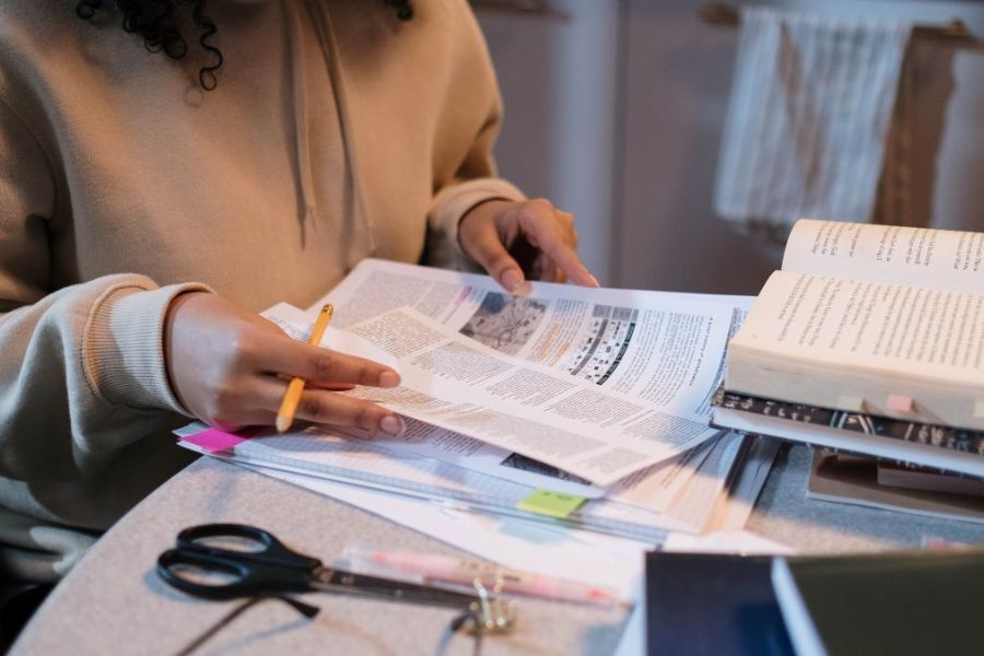 A young person studying at their desk at home