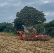 tractor sowing seeds in a dug field