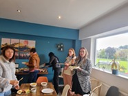 Adult students sharing food in a classroom