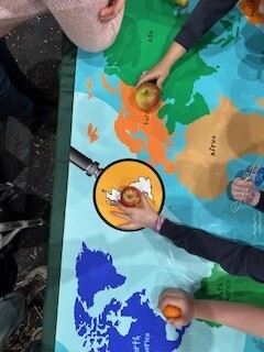 childrens hands on a map for a where does fruit come from activity