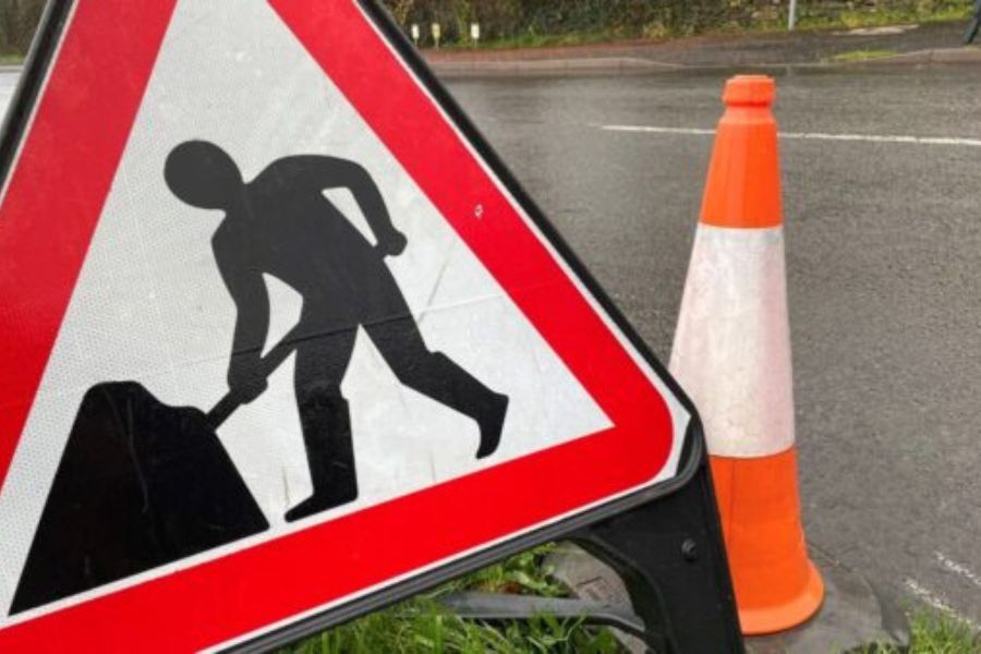A road works traffic sign on the road indicating road works