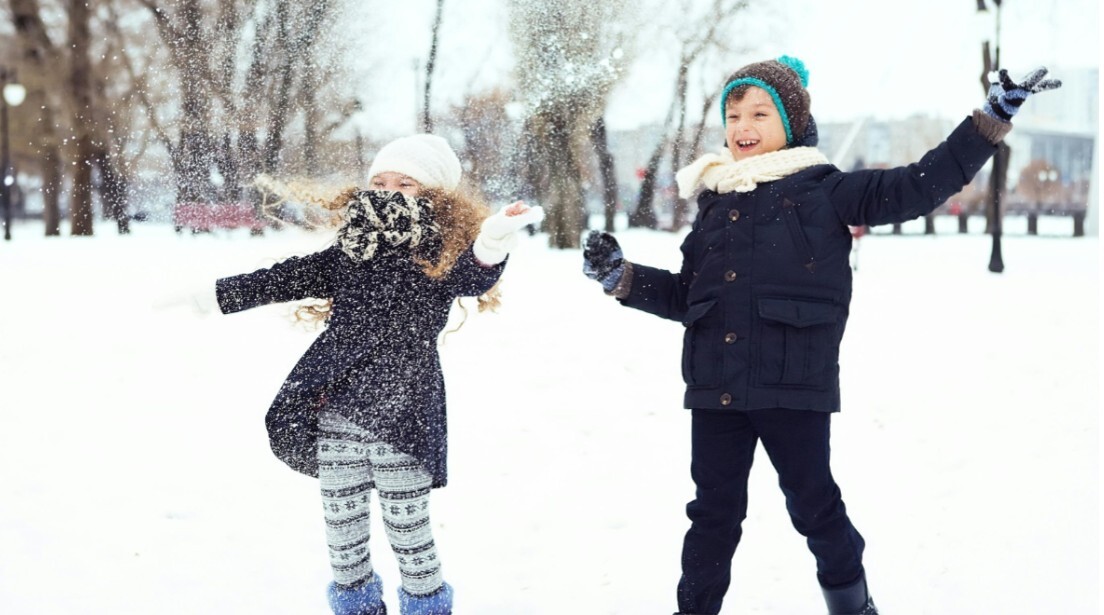 2 children playing in the snow