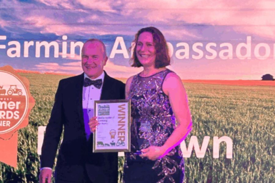 Bev Brown collecting her award on stage at the award ceremony