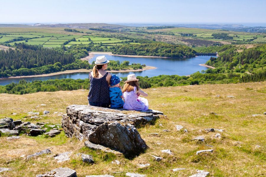 A young family sat at the top of a Devon hill overlooking the valley