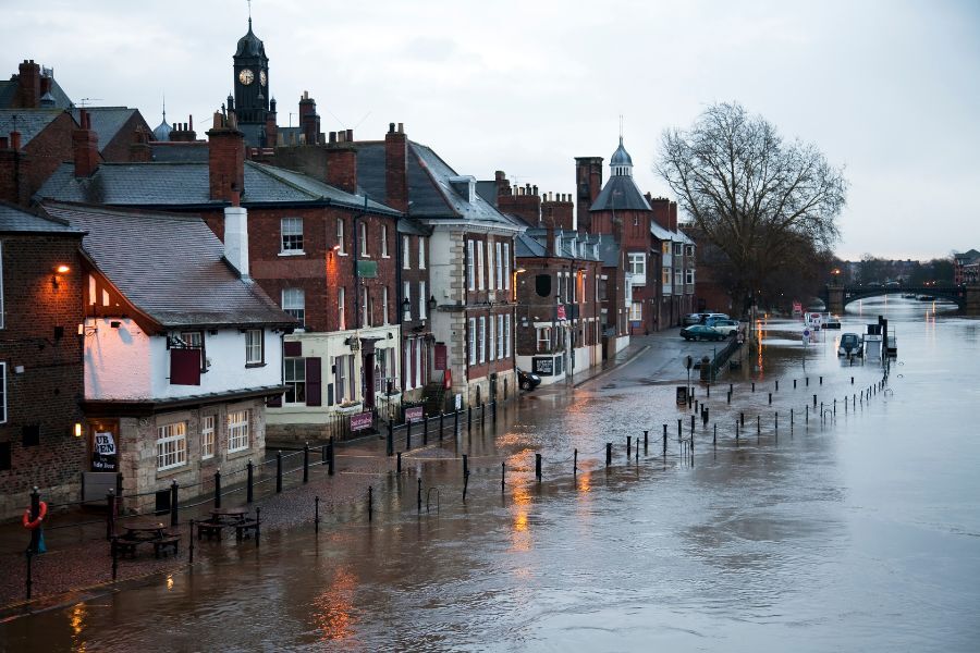 A river burst its banks. The adjacent road and properties are flooded