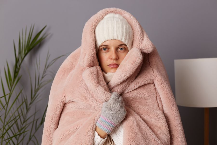 A woman in a warm coat with a wooly hat on