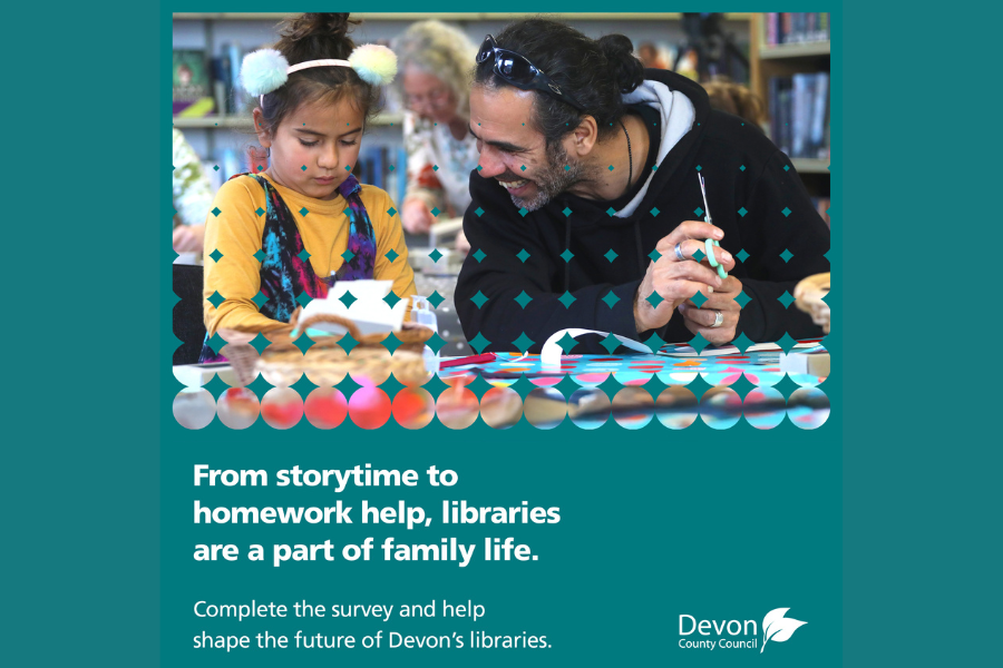 Adult and child doing a craft activity together at a library table with colourful paper shapes.