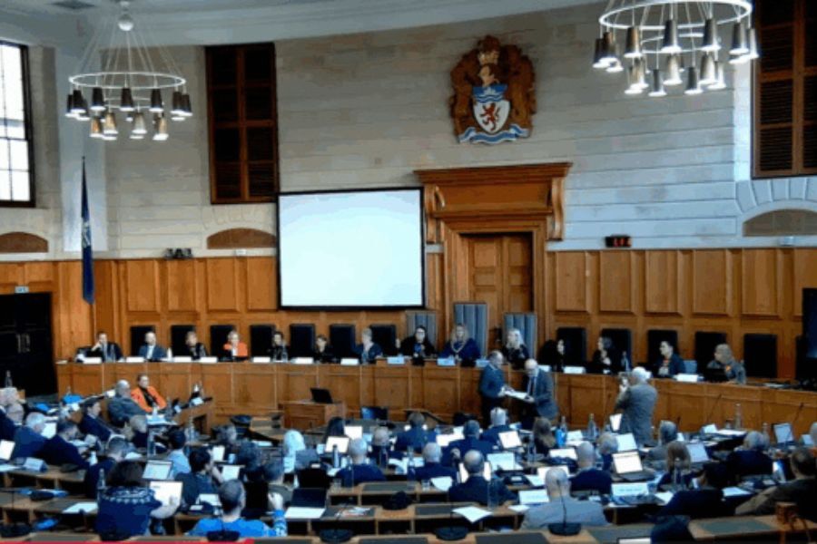 Photo of councillors at a meeting in a the council chamber at County Hall, Exeter
