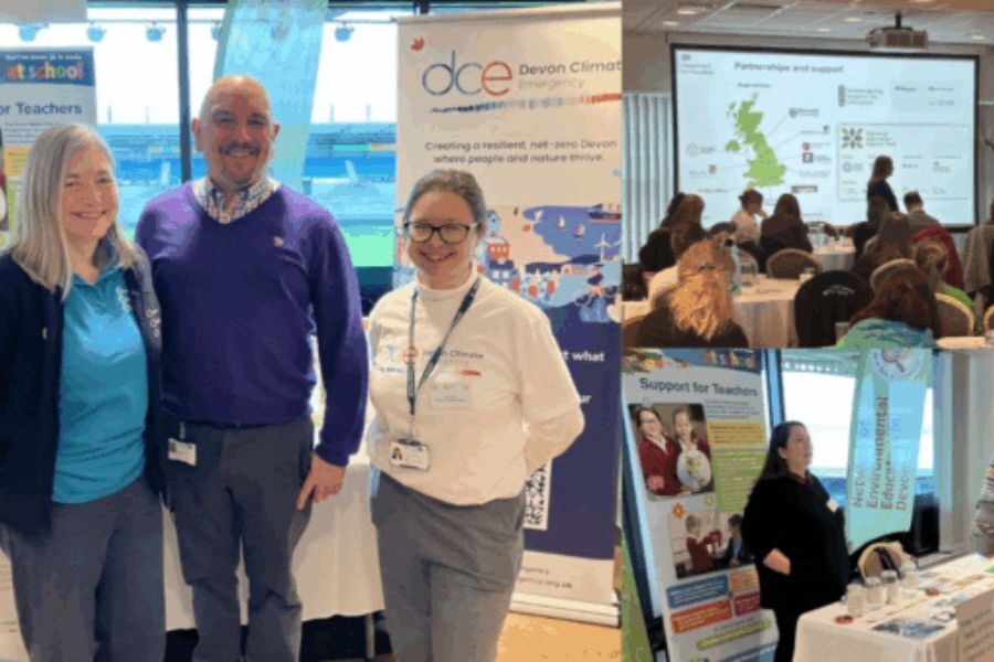 Jack Newton, stood with colleagues in front of a Devon Climate Emergency pull-up banner at the conference