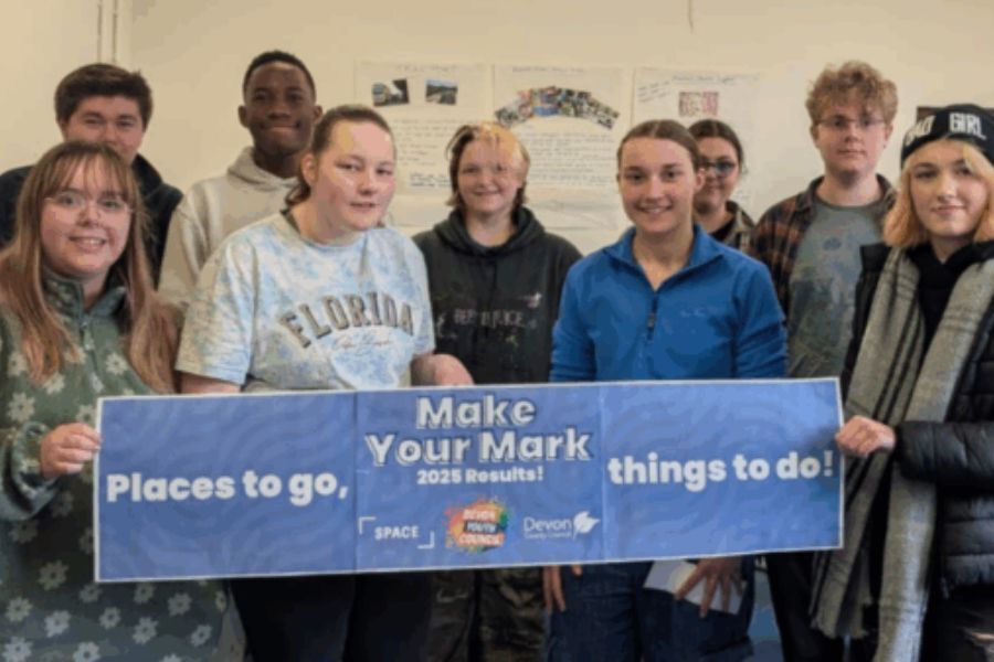 Members of the Devon Youth Council holding a banner that reads 'Make Your Mark, Places to Go, Things to Do'