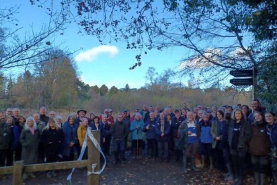A large crowd of visitors standing at gates on the new trail at Stover Country Park