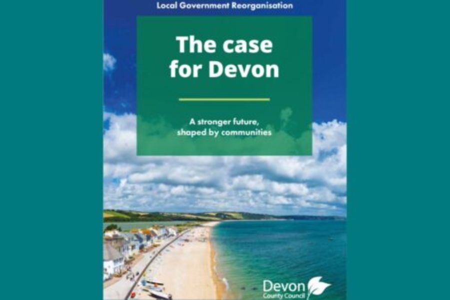The front cover of the local government reorganisation business plan document, showing a Devon beach and blue sky