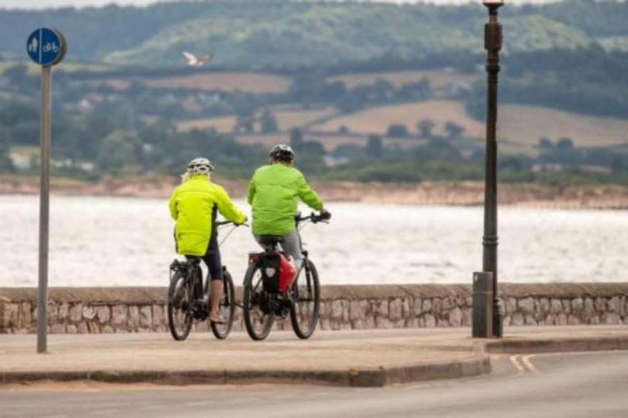 Cyclists riding on the cycle path along Exmouth sea front