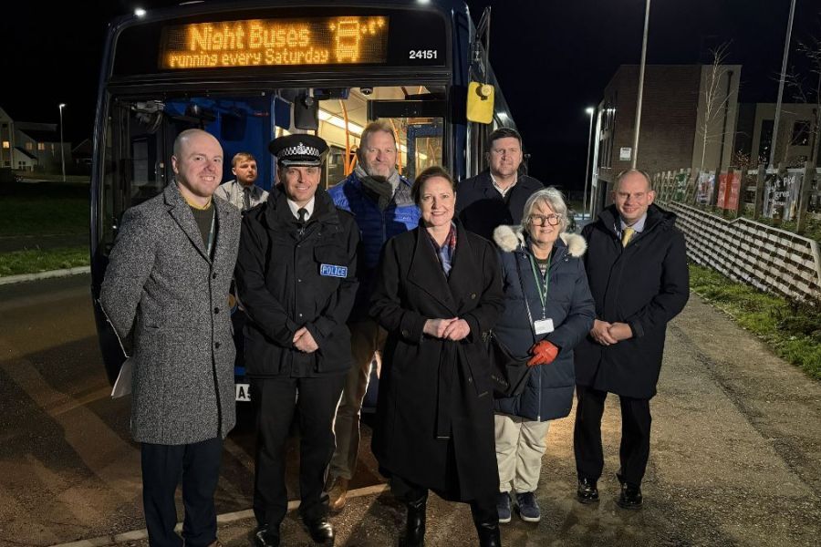 VIPs stood in front of night bus 