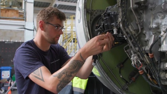 Aircraft engineer working on an engine