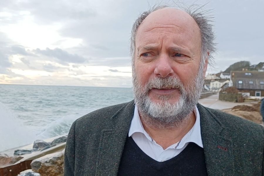 Councillor Julian Brazil, Leader of Devon County Council, stood by the sea at Torcross talking about the damage from storm Ingrid