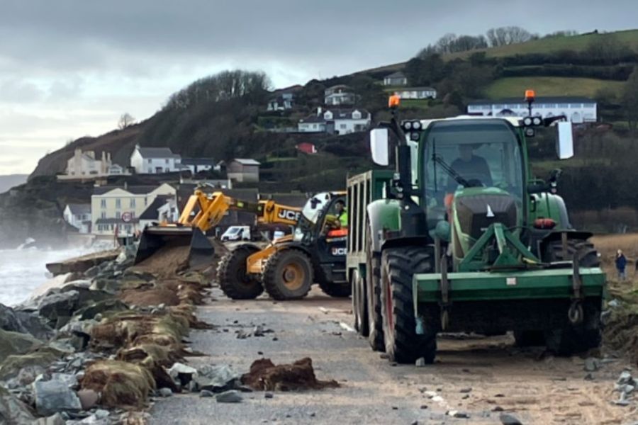 Diggers clearing up after the damage in Torcross caused by storms Ingrid and Chandra