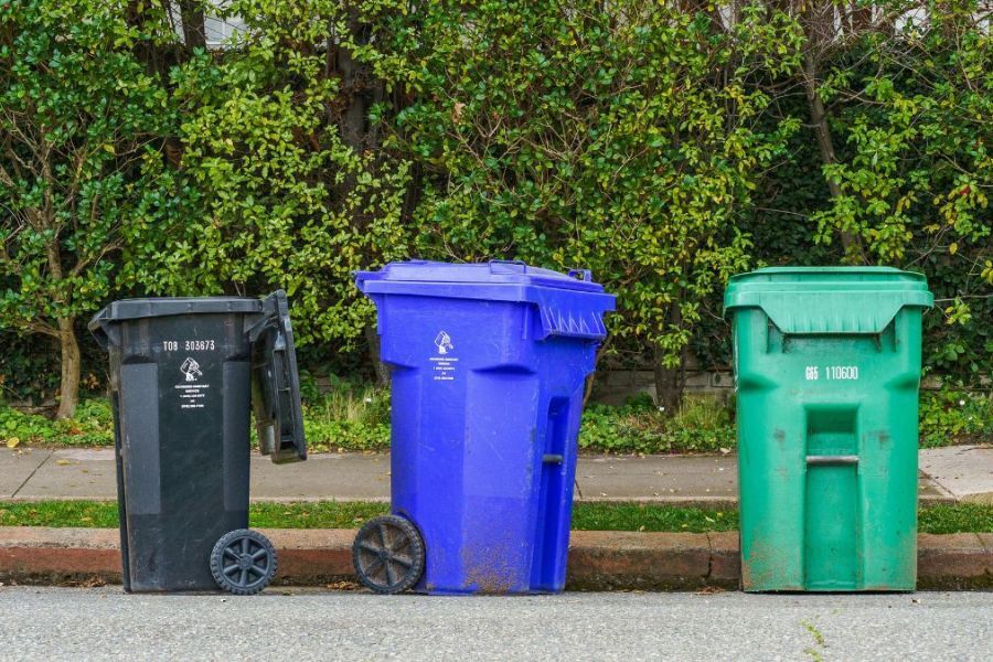 Three wheely bins side by side in a drive