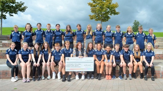 Group of young people together with Holywood Trust cheque