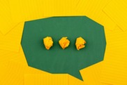 A green speech bubble is depicted against a yellow background