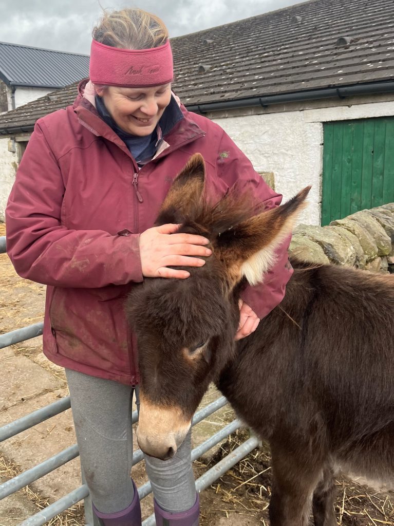 Fund application photograph of woman with donkey