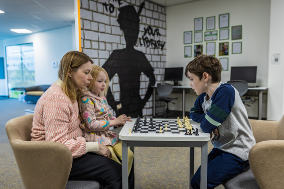 A woman and a child playing chess in the Children's Library