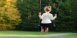girl on a swing in a playground 