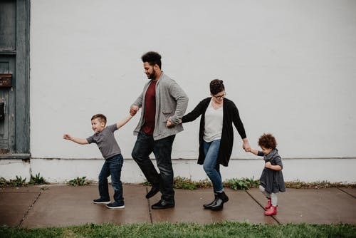 family holding hands on a walk