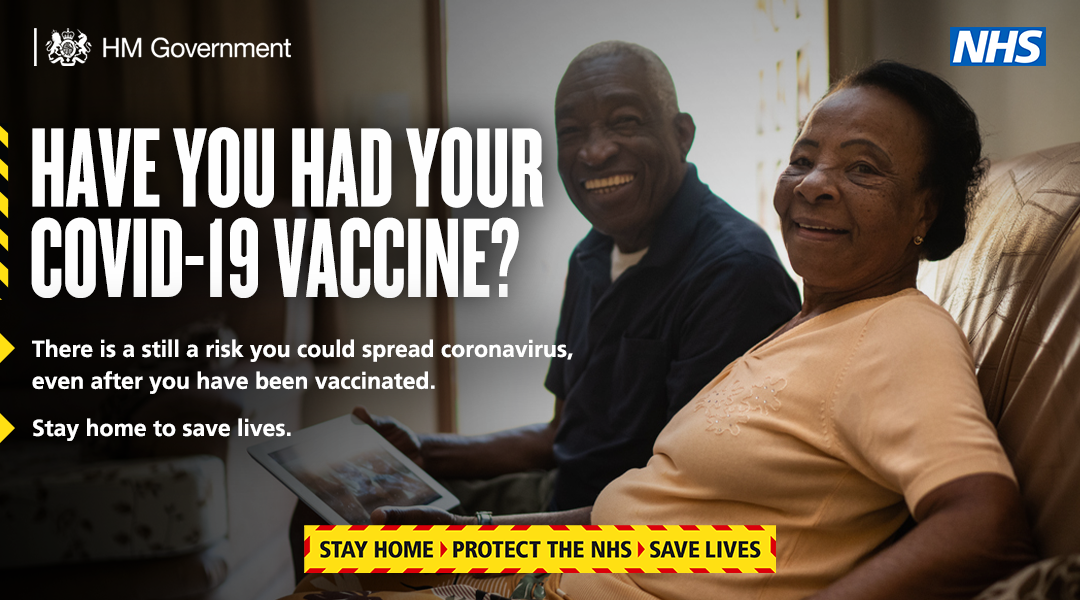 man and woman at home - stay home after your vaccine 