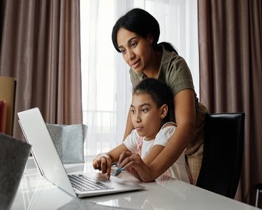 mother and daughter at laptop