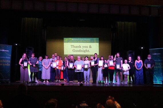 We Love Carers: Picture of award winners on stage with their certificates