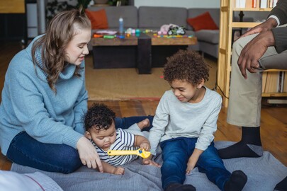 Mum playing on the floor with her two children