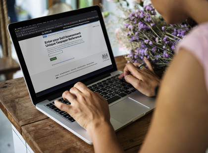 Woman looking at the Self-employment Income Support Scheme web page on her laptop