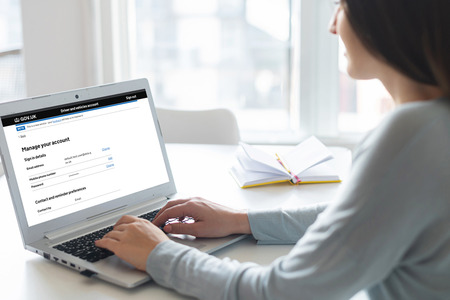Woman viewing Driver and vehicles account on a laptop