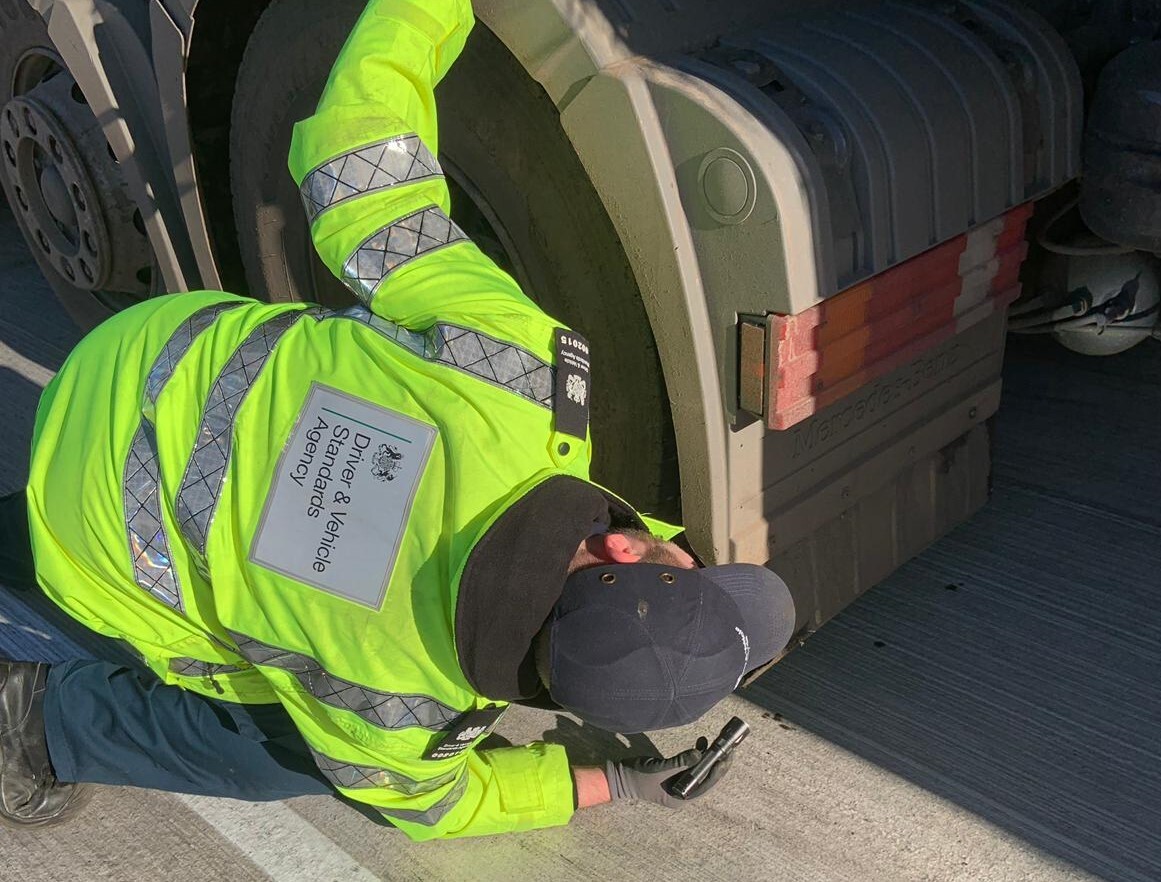 vehcile examiner looking under lorry
